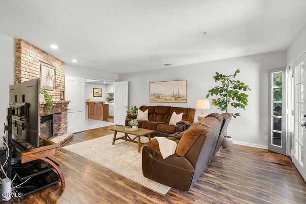 Fireplace, Interior, Living room, Recessed Lighting, Stone Walls, Wood Texture Flooring