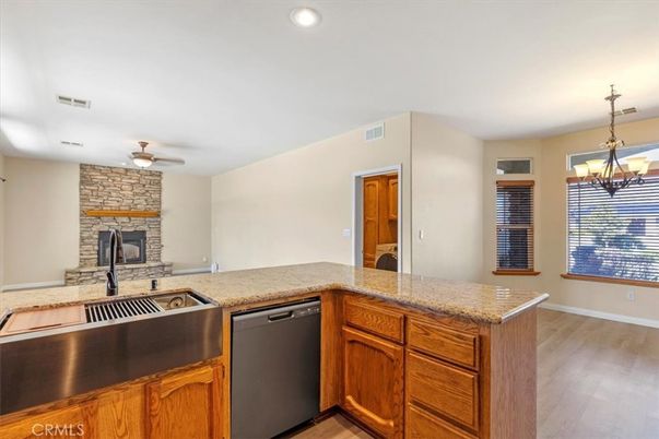 Chandelier, Fireplace, Interior, Kitchen, Recessed Lighting, Stone Walls, Wood Texture Flooring