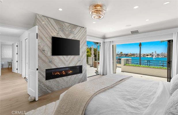 Bedroom, Fireplace, Interior, Marble Walls, Recessed Lighting, Water, Wood Texture Flooring