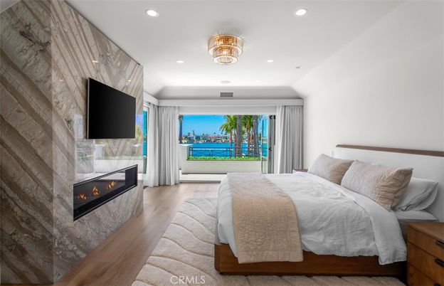 Bedroom, Fireplace, Interior, Recessed Lighting, Water, Wood Texture Flooring