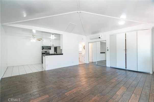 Empty room, Interior, Kitchen, Recessed Lighting, Stainless Steel Appliances, Wood Texture Flooring