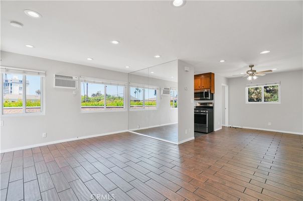 Empty room, Interior, Kitchen, Recessed Lighting, Stainless Steel Appliances, Wood Texture Flooring