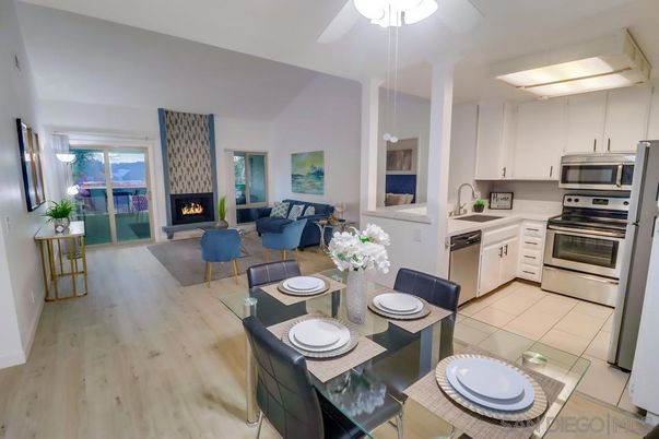 Dining room, Fireplace, Interior, Kitchen, Living room, Pendant Lights, Stainless Steel Appliances, Wood Texture Flooring