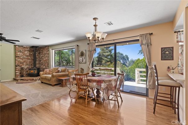 Chandelier, Dining room, Fireplace, Interior, Living room, Stone Walls, Wood Texture Flooring