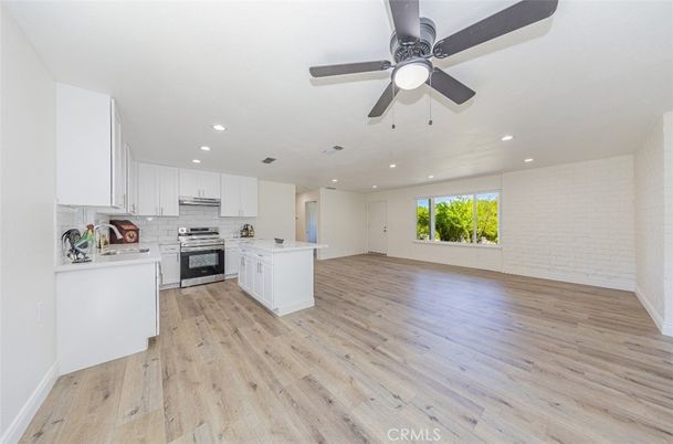 Empty room, Interior, Kitchen, Recessed Lighting, Stainless Steel Appliances, Wood Texture Flooring