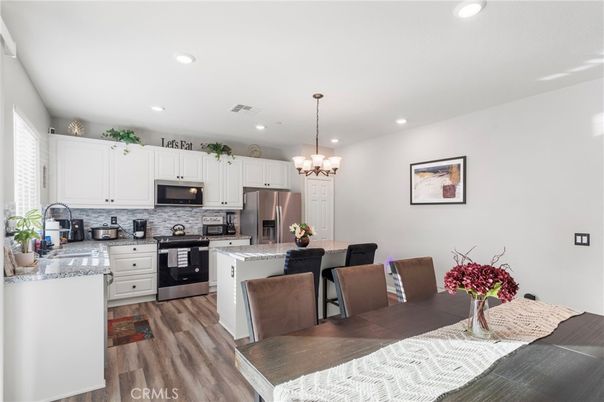 Chandelier, Dining room, Interior, Kitchen, Pendant Lights, Recessed Lighting, Stainless Steel Appliances, Wood Texture Flooring
