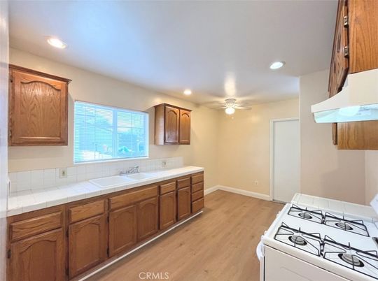 Interior, Kitchen, Recessed Lighting, Tile Countertops, Wood Texture Flooring
