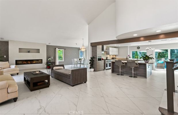 Chandelier, Dining room, Fireplace, Interior, Kitchen, Living room, Marble, Pendant Lights, Recessed Lighting, Stainless Steel Appliances, Wooden Beams