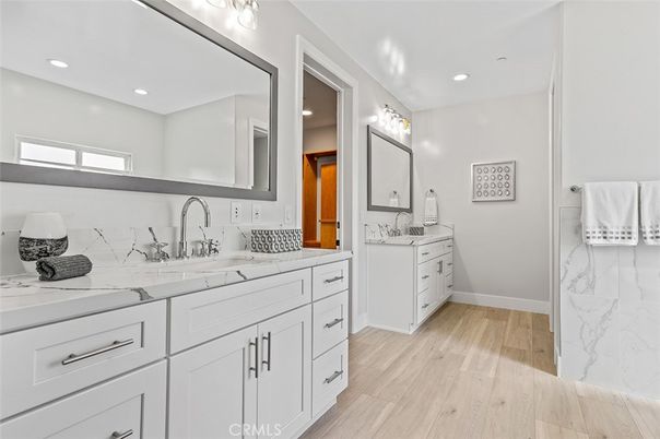 Bathroom, Dual Sink Vanities, Interior, Marble Walls, Recessed Lighting, Wood Texture Flooring