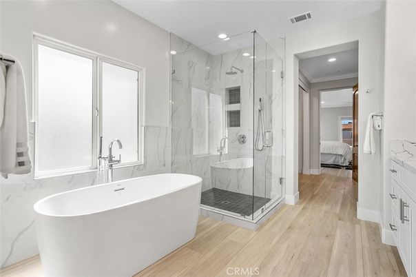 Bathroom, Bedroom, Free Standing Baths, Glass Shower, Interior, Marble Walls, Recessed Lighting, Wood Texture Flooring