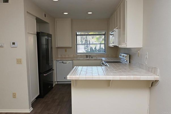 Interior, Kitchen, Recessed Lighting, Tile Countertops, Wood Texture Flooring