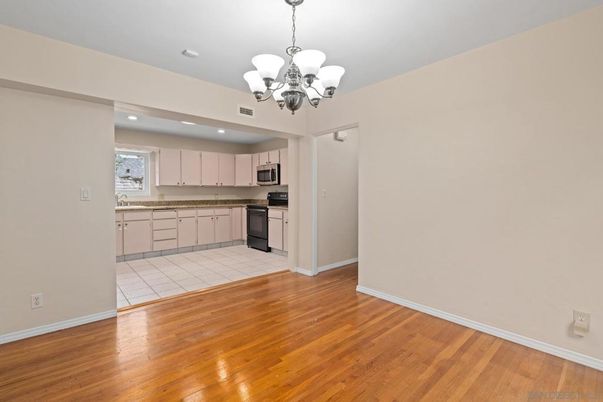 Chandelier, Empty room, Interior, Kitchen, Recessed Lighting, Stainless Steel Appliances, Wood Texture Flooring