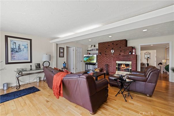 Fireplace, Interior, Living room, Recessed Lighting, Stone Walls, Wood Texture Flooring