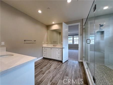 Bathroom, Dual Sink Vanities, Glass Shower, Interior, Recessed Lighting, Wood Texture Flooring
