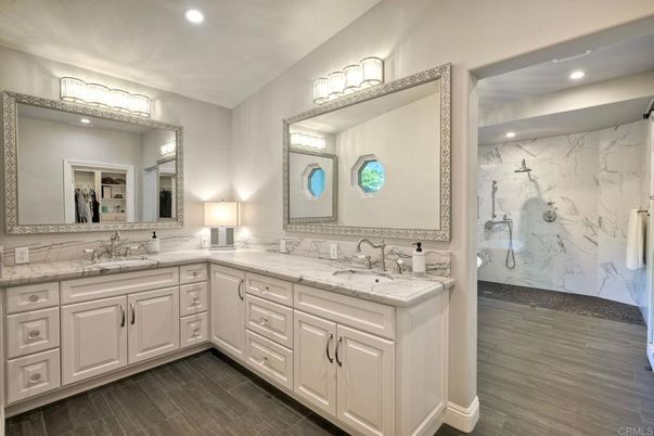 Bathroom, Dual Sink Vanities, Interior, Marble Walls, Recessed Lighting, Wood Texture Flooring