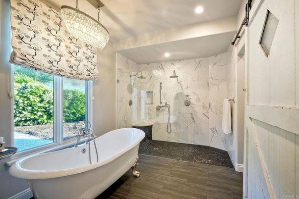 Bathroom, Chandelier, Free Standing Baths, Glass Shower, Interior, Marble Walls, Recessed Lighting, Wood Texture Flooring