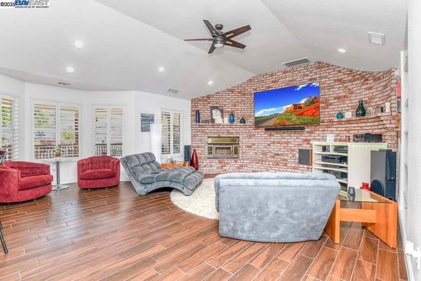 Fireplace, Interior, Living room, Recessed Lighting, Stone Walls, Wood Texture Flooring