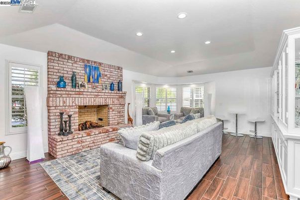 Fireplace, Interior, Living room, Recessed Lighting, Stone Walls, Wood Texture Flooring