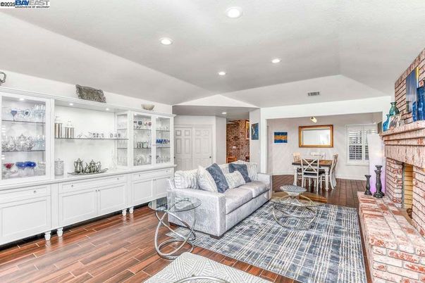 Dining room, Fireplace, Interior, Living room, Recessed Lighting, Stone Walls, Wood Texture Flooring