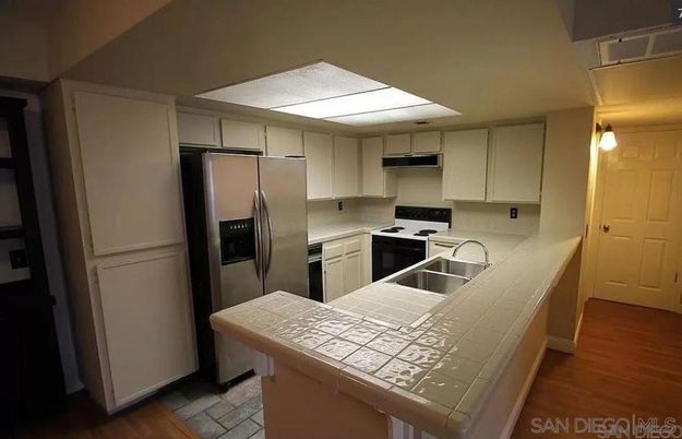 Interior, Kitchen, Stainless Steel Appliances, Tile Countertops, Wood Texture Flooring