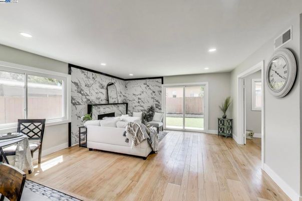 Fireplace, Interior, Living room, Marble Walls, Recessed Lighting, Wood Texture Flooring
