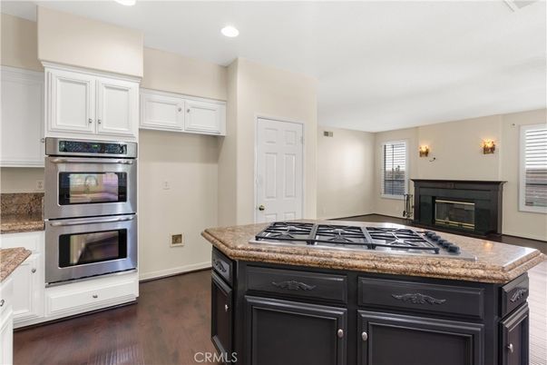 Fireplace, Interior, Kitchen, Recessed Lighting, Stainless Steel Appliances, Wood Texture Flooring