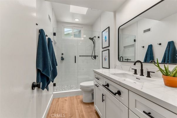 Bathroom, Dual Sink Vanities, Glass Shower, Interior, Recessed Lighting, Wood Texture Flooring