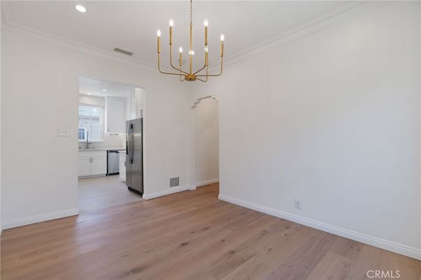 Empty room, Interior, Kitchen, Pendant Lights, Recessed Lighting, Stainless Steel Appliances, Wood Texture Flooring