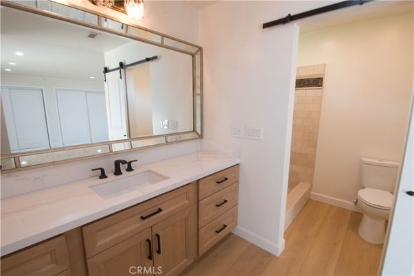 Bathroom, Dual Sink Vanities, Interior, Recessed Lighting, Wood Texture Flooring