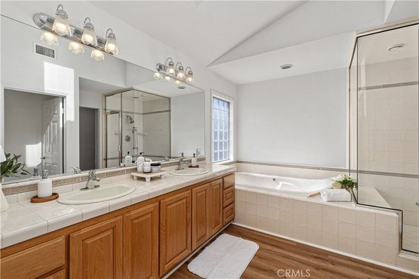 Bathroom, Dual Sink Vanities, Glass Shower, Interior, Tile Countertops, Wood Texture Flooring