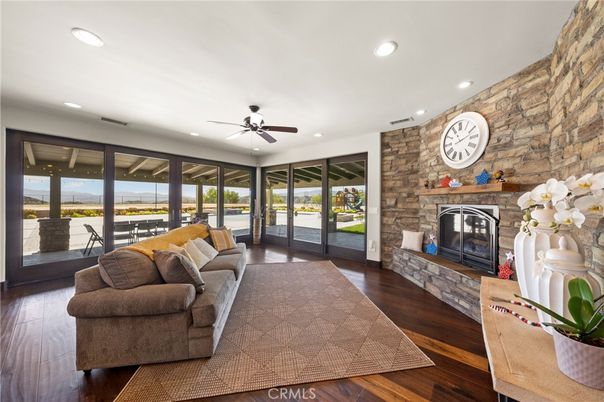Fireplace, Interior, Living room, Recessed Lighting, Stone Walls, Water, Wood Texture Flooring