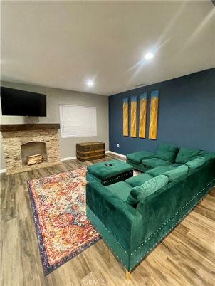 Fireplace, Interior, Living room, Recessed Lighting, Stone Walls, Wood Texture Flooring