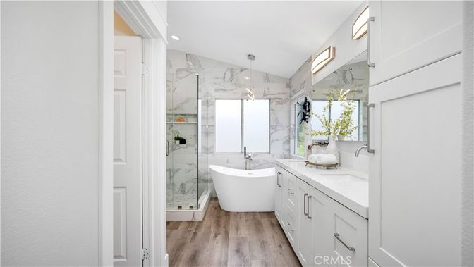 Bathroom, Dual Sink Vanities, Free Standing Baths, Glass Shower, Interior, Marble Walls, Recessed Lighting, Wood Texture Flooring