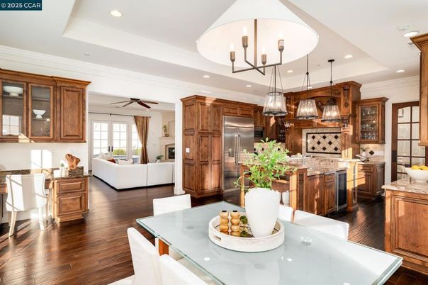 Chandelier, Dining room, Interior, Kitchen, Living room, Pendant Lights, Recessed Lighting, Stainless Steel Appliances, Wood Texture Flooring