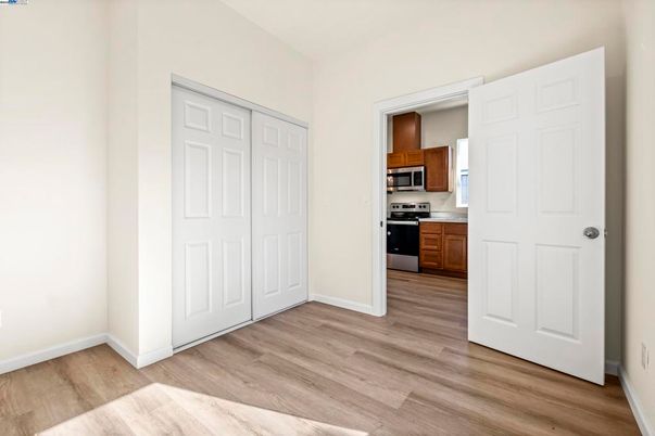 Empty room, Interior, Kitchen, Stainless Steel Appliances, Wood Texture Flooring