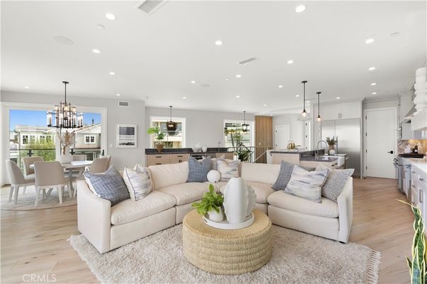 Chandelier, Dining room, Interior, Kitchen, Living room, Pendant Lights, Recessed Lighting, Stainless Steel Appliances, Wood Texture Flooring