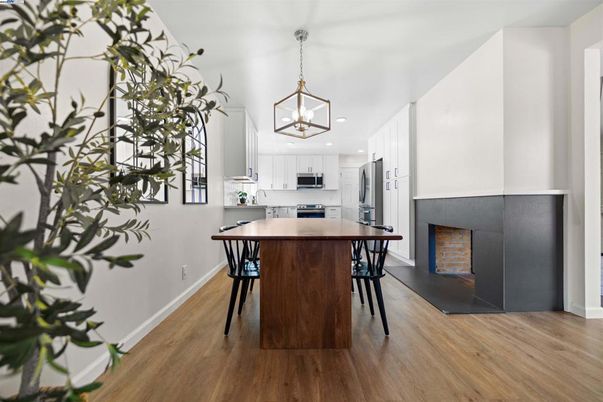 Dining room, Fireplace, Interior, Kitchen, Pendant Lights, Recessed Lighting, Stainless Steel Appliances, Wood Texture Flooring