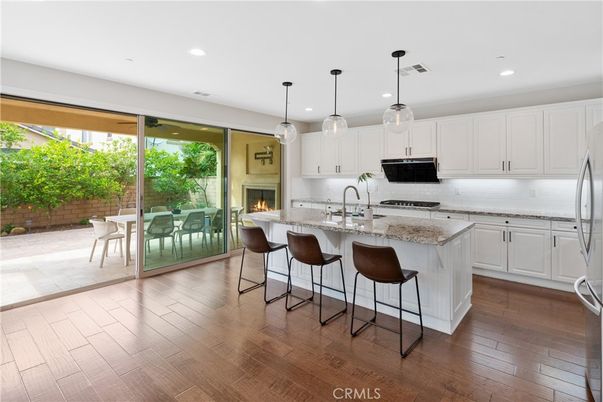 Fireplace, Interior, Kitchen, Pendant Lights, Recessed Lighting, Stainless Steel Appliances, Wood Texture Flooring