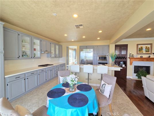 Dining room, Fireplace, Interior, Kitchen, Recessed Lighting, Stainless Steel Appliances, Wood Texture Flooring