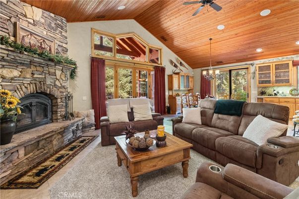 Chandelier, Dining room, Fireplace, Interior, Living room, Pendant Lights, Recessed Lighting, Stone Walls, Wooden Ceilings
