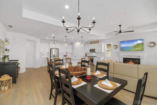 Chandelier, Dining room, Fireplace, Interior, Kitchen, Living room, Pendant Lights, Recessed Lighting, Stainless Steel Appliances, Wood Texture Flooring