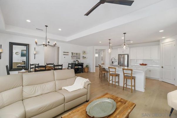 Chandelier, Dining room, Interior, Kitchen, Living room, Pendant Lights, Recessed Lighting, Stainless Steel Appliances, Wood Texture Flooring