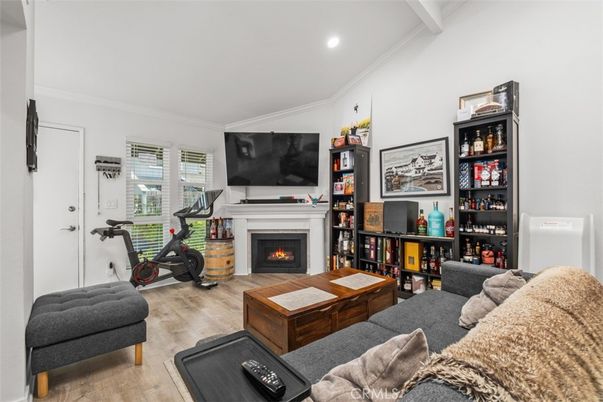 Fireplace, Fitness Equipment, Interior, Living room, Recessed Lighting, Wood Texture Flooring