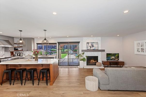 Fireplace, Interior, Kitchen, Living room, Pendant Lights, Recessed Lighting, Stainless Steel Appliances, Wood Texture Flooring