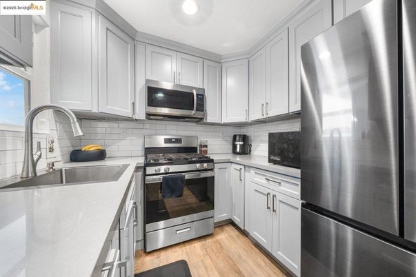 Interior, Kitchen, Recessed Lighting, Stainless Steel Appliances, Wood Texture Flooring