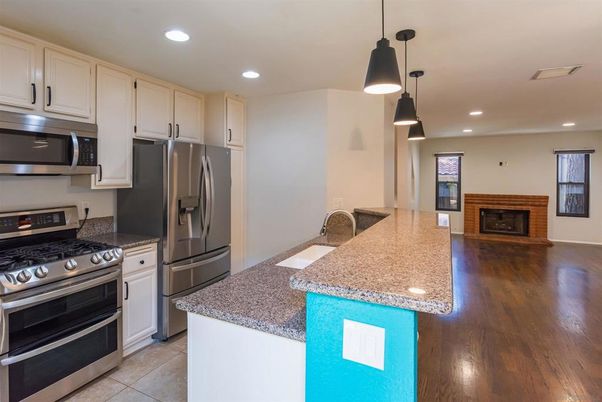 Fireplace, Interior, Kitchen, Pendant Lights, Recessed Lighting, Stainless Steel Appliances, Wood Texture Flooring