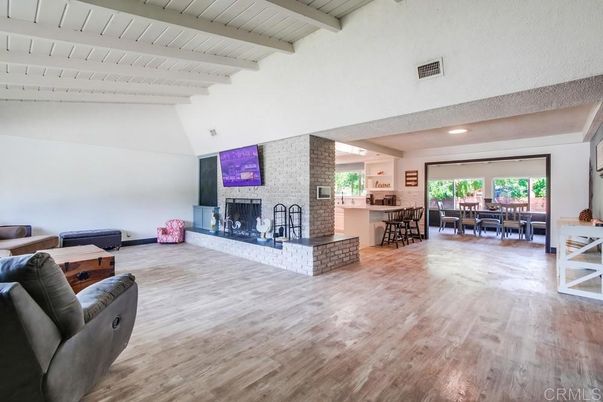 Dining room, Fireplace, Interior, Living room, Recessed Lighting, Stone Walls, Wood Texture Flooring