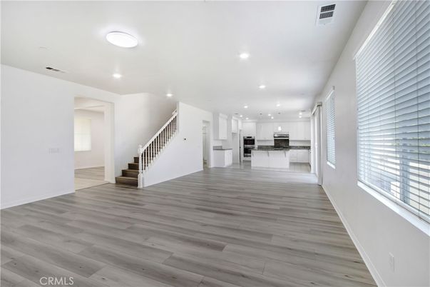 Empty room, Interior, Kitchen, Recessed Lighting, Stainless Steel Appliances, Wood Texture Flooring