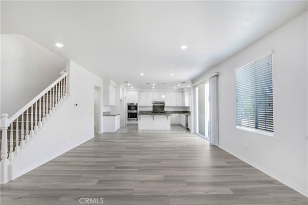 Empty room, Interior, Kitchen, Pendant Lights, Recessed Lighting, Stainless Steel Appliances, Wood Texture Flooring