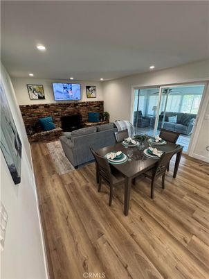 Dining room, Fireplace, Interior, Living room, Recessed Lighting, Stone Walls, Wood Texture Flooring